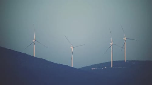 Wind Turbines Spinning on Rural Hills