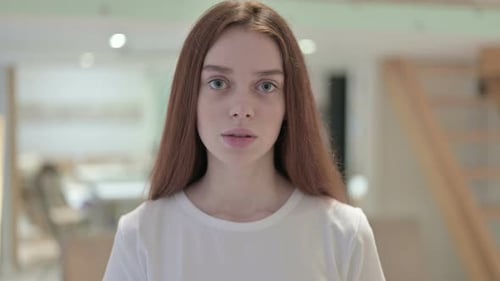 Young Woman Stares at Camera