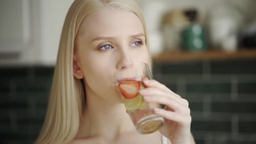 Woman Drinks Fruit Infused Water for Healthy Lifestyle