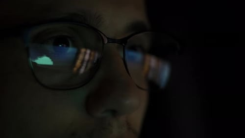 Close up of Man with Glasses Looking at Screen