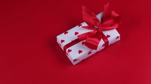 Beautifully Wrapped Gift with Red Hearts and Ribbon