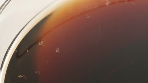 Fresh sparkling dark soft drink in the glass close-up 4K 2160p 30fps UltraHD footage - Bubbles of