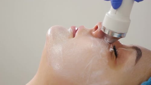 Beauty Clinic and Machine Cosmetology. Professional Cosmetologist Working with Ultrasonic Facial
