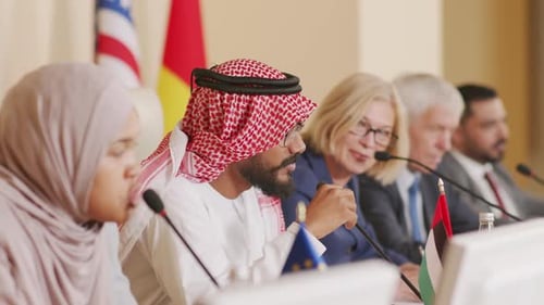 People at International Meeting with Microphones and Flags