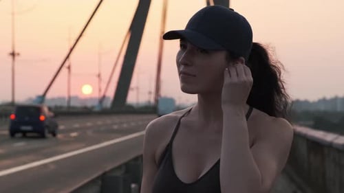 Close Up of Confident Woman Runner in Sportswear and Earphones Outdoors
