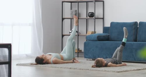 Woman and Child Exercising Together at Home