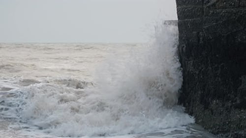Powerful Waves Crashing Against a Stone Seawall