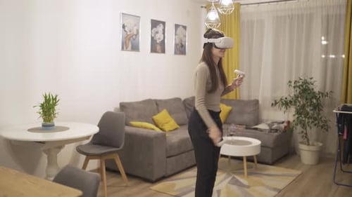 Woman Using Virtual Reality Headset and Controllers at Home