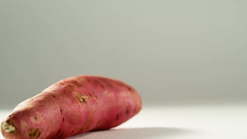Uncooked Sweet Potato on White Surface