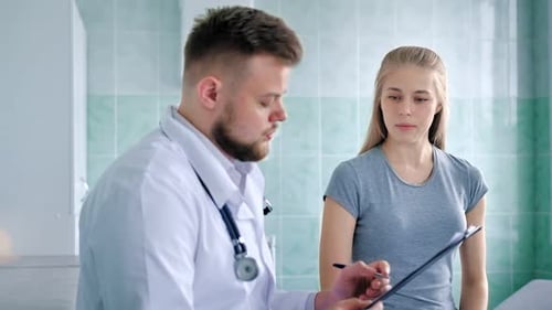 Doctor Consults with Woman in Medical Office