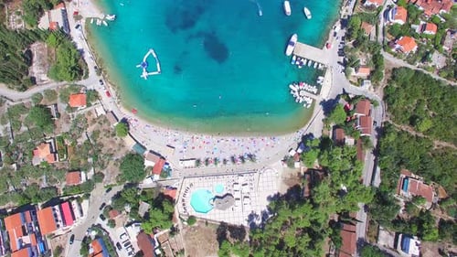 Flying above touristic resort at turquoise bay of Solta island