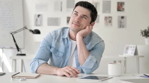 Man Sitting at Desk Contemplating Ideas