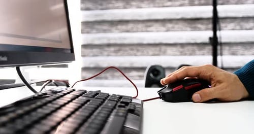 Hand Using Computer Mouse in Workplace