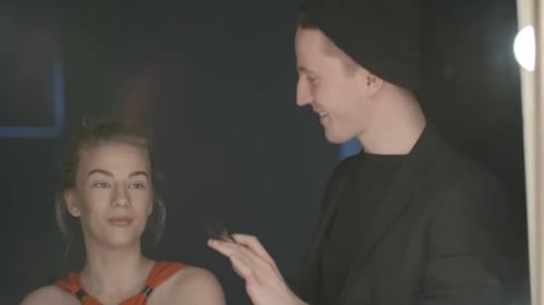 Makeup Artist Applying Foundation to Blonde Model