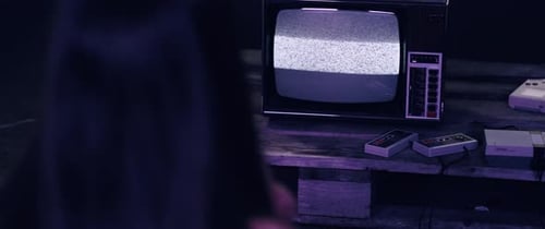 Girl in front of an old flickering tv