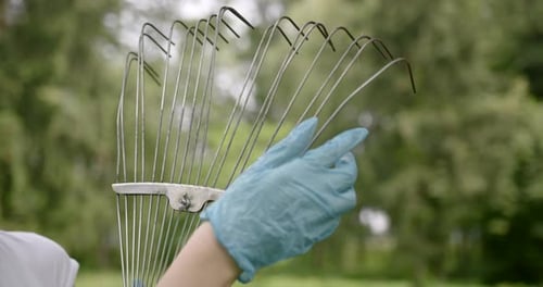 Young Girl Preparing Rake for Volunteer Job