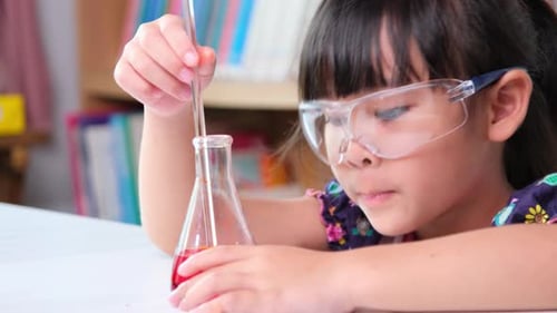 Girl Scientist Conducts Experiment at School Lab