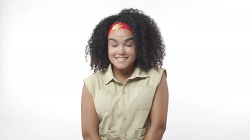 Smiling Woman with Curly Hair in Studio