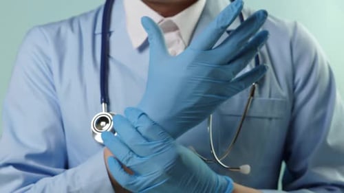 Health Professional Putting on Medical Gloves