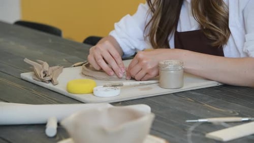 Woman Working on Pottery in a Studio