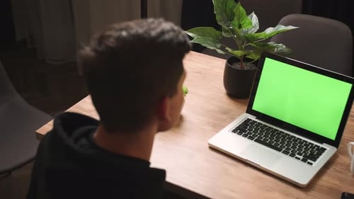 Back View of Man Waving Hand on Camera Laptop Green Screen Chromakey Man Has Video Call Chatting on
