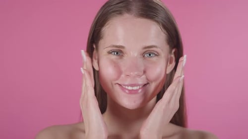 Woman Applying Skincare Product to Face