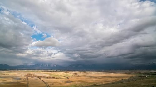 Vast Rural Landscape with Dramatic Mountain Backdrop