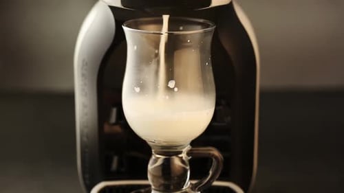 Pouring White Beverage into a Glass Close Up