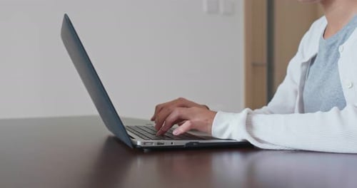 Woman Typing on Laptop at Home Indoors