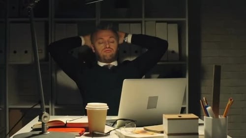 Businessman Working at Desk at Night