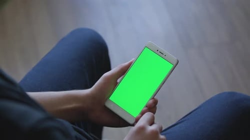 Closeup of Male Hands Holding Smart Phone with Green Screen Prekeyed for Effects. Useful Mobile