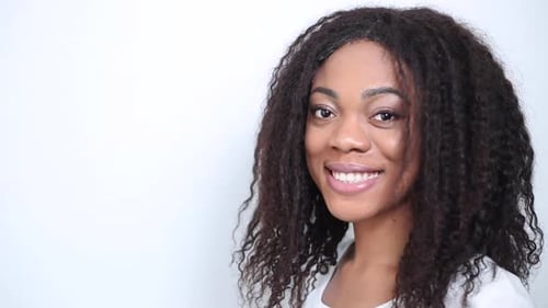 Portrait of a happy young African American young woman with curly hair.