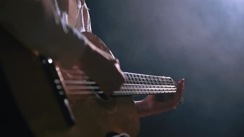 Girl Playing Guitar at Dark Studio