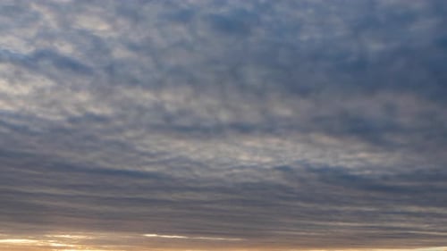 Beautiful Sunset on the Background of the Cloudy Sky