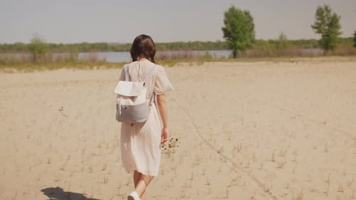 Happy Woman on Walking Beach. Back View