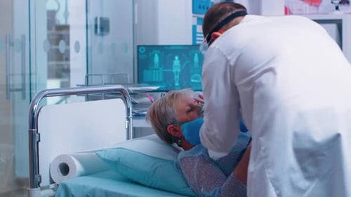 Doctor Giving Oxygen to Senior Woman in Hospital