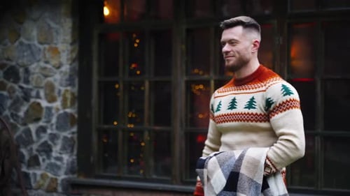 Smiling young guy on cottage background.