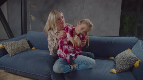 Mother and Child Bonding Together on the Couch