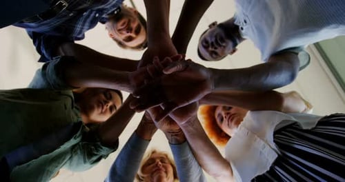 Team of executives forming hand stack