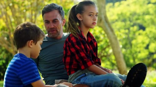 Family relaxing in park 4k