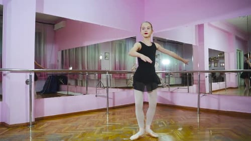Graceful girl practicing ballet in the Studio. Performs the elements of dance. Slow motion.