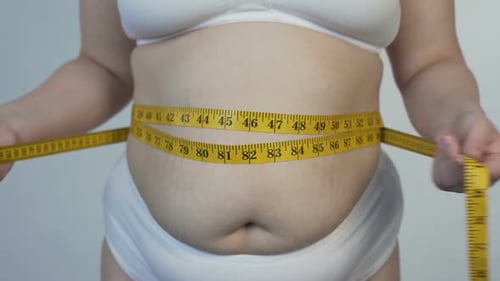 Fatty Woman Taking Belly Measurements, Health Problems and Overweight, Diet