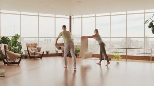 Couple Prepares for Yoga in Modern Apartment