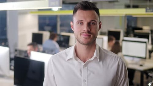 Smiling Man Poses in Modern Office Environment