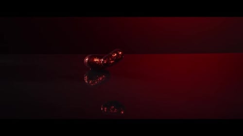 Valentine's Day decorations falling and bouncing on a reflective surface - VALENTINES 007
