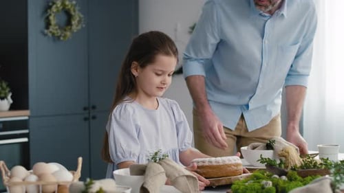 Family Prepares Easter Cake Together in Bright Kitchen