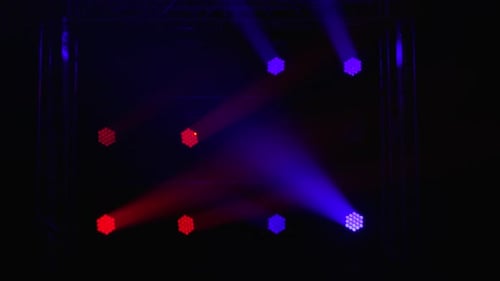 Stage Lighting Effects with Purple, Blue, and Red Beams