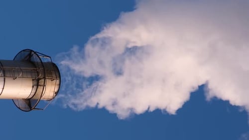 Smoke Stack Emitting Plume into Blue Sky
