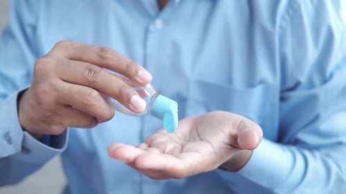 Adult Using Hand Sanitizer for Personal Hygiene