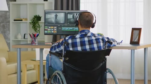 Adult in Wheelchair Video Editing at Desk